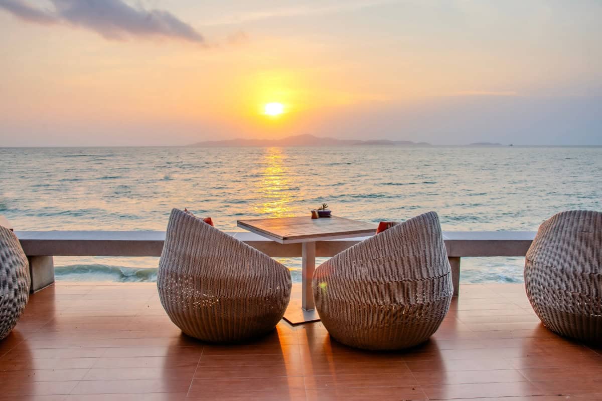 oceanfront seats at beach bar in pattaya at sunset