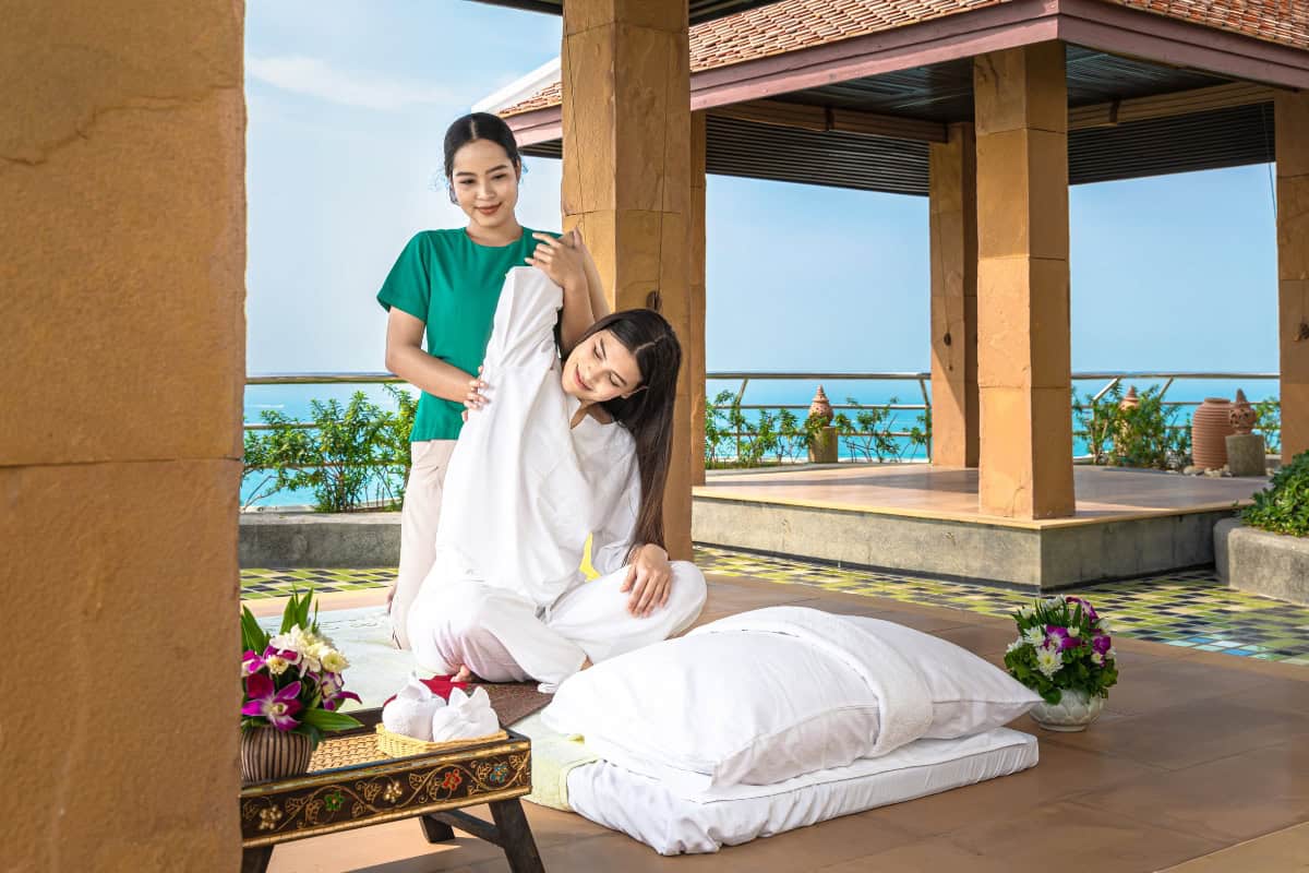woman getting best thai massage in pattaya at cliff spa outdoor terrace with ocean view